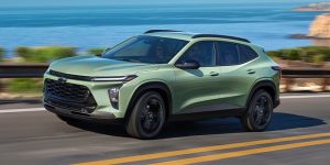 2024 Chevrolet Trax driving along the bank side. 